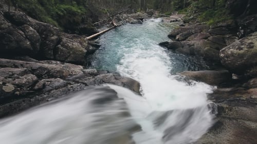 Mountain River with Cascade Waterfall in Forest