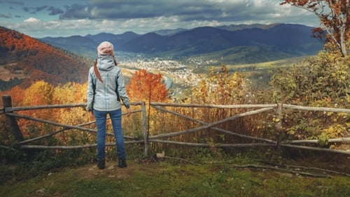 Young Woman Raising Hands on Mountain View Point