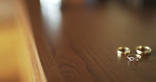 Close Up of Wedding Rings on Wood
