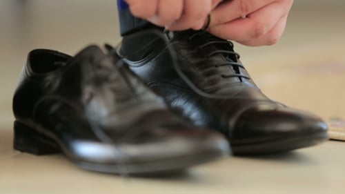 Man Tying Black Leather Dress Shoe Laces