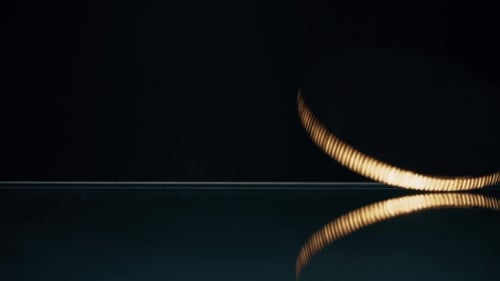 Bitcoin Coin Spinning and Falling Down From the Glass Desk