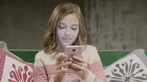 Girl Using Smartphone Indoors
