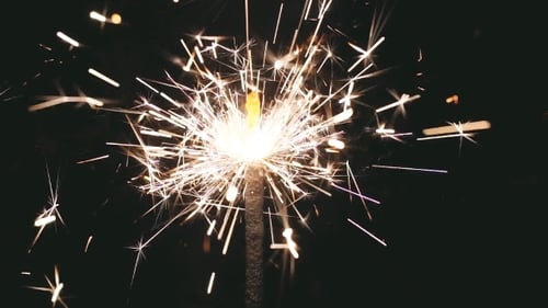 Sparkler Emitting Sparks on a Dark Background