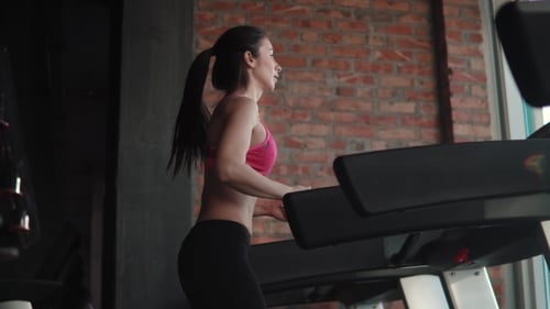 Portrait of a Girl on the Treadmill in the Gym