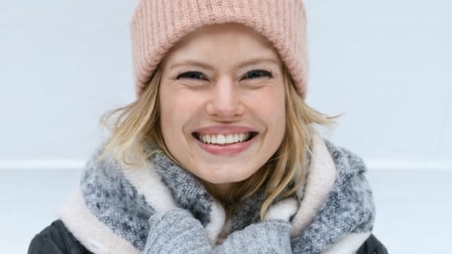 Smiling Woman Wearing Winter Hat and Scarf