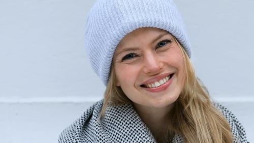 Smiling Blond Woman Wearing Hat Posing