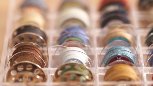 Colorful Sewing Thread Spools in Clear Container
