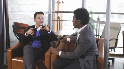 Two Men Sit at the Office, Talking and Negotiate