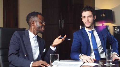 Business Discussion Between Two Young Professionals Indoors
