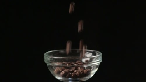 Chocolate Cereal Being Poured Into a Bowl