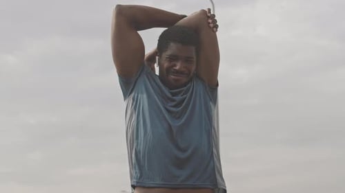 Man Stretches Before Exercise In the City