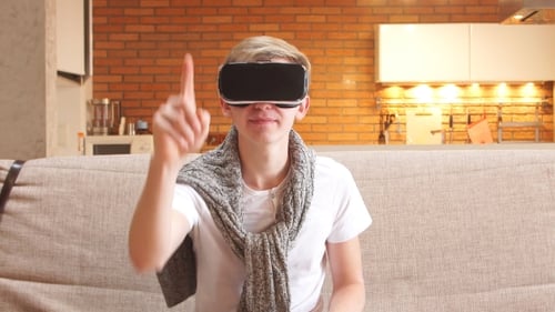Young Adult Using VR Headset at Home