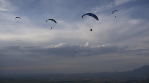 Paragliders in the Deep Blue Sky