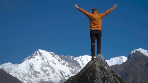 Man Reaching Up Top of Mountain and Raised Hands