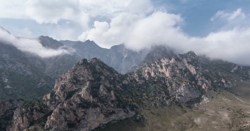 Mountains and Clouds with Paragliders in Flight