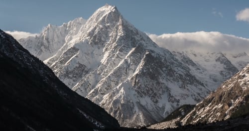 White Snowy Mountain with Ice Peaks in the Middle of the Valley