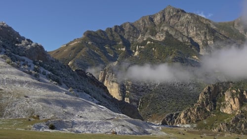 First Snow on Green Grass in Beautiful High Mountains