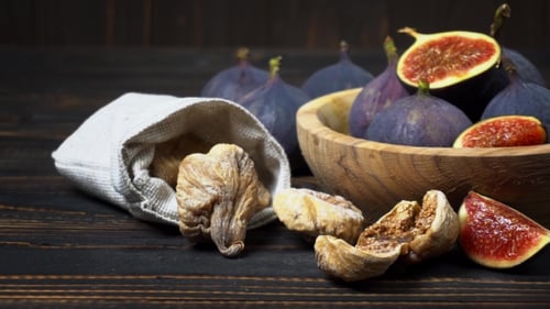 Fresh and Dried Fig Isolated on Wooden Background