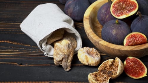 Fresh and Dried Fig Isolated on Wooden Background