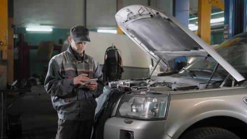 Car Mechanic with Tablet Near Car