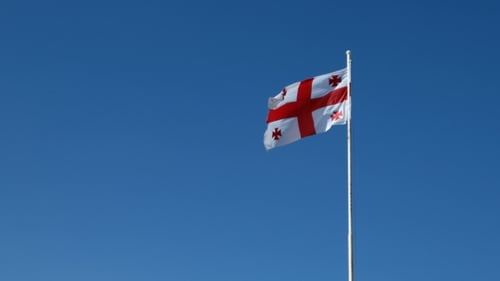 Georgian Flag Waving Against a Clear Blue Sky
