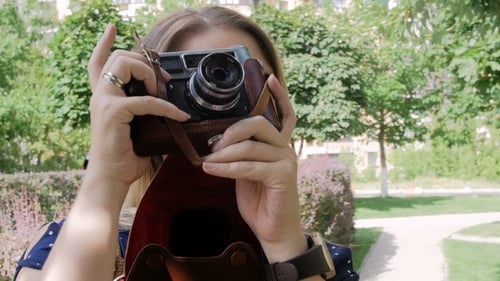 Footage of Young Woman Making Photo on Old Manual Camera at Park