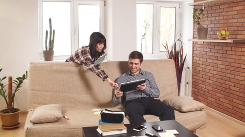 Young Adults Using Tablets in Living Room