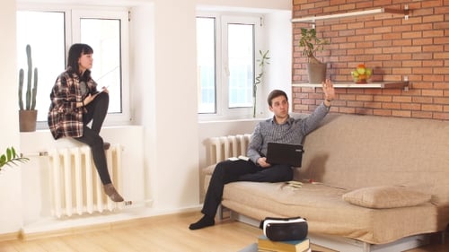 Young Adults Talking in Cozy Apartment Living Room