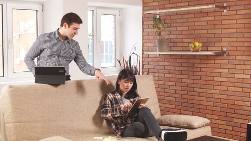 Young Adults Using Tablets Together at Home