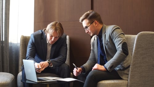 Businessmen Talking in Office Setting