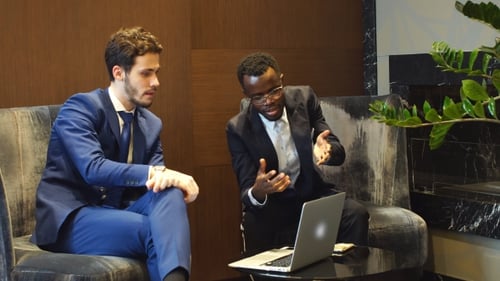 Two Business Men Discussing Ideas in Office Setting