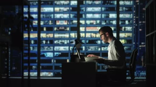 Portrait of Thoughtful Successful Businessman Working on Laptop Computer in His Big City Office at