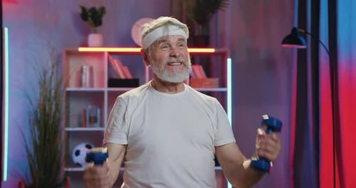 Senior Man Lifting Dumbbells in Home Gym