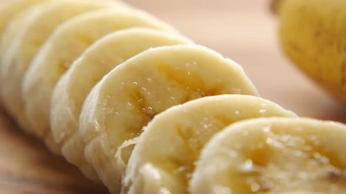 Close Up of Slice of Banana Glass of Milk on Table