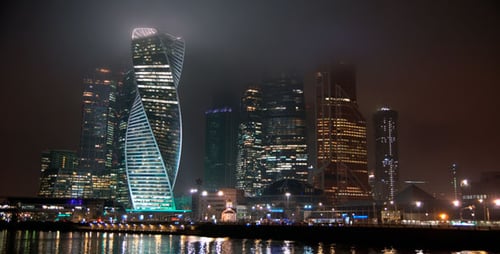 Modern Cityscape at Night with Illuminated Buildings