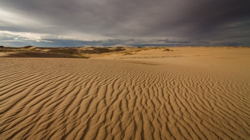 Clouds in the Desert Above the Sand Dunes