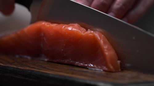 Close Up of Salmon Fillet Being Sliced