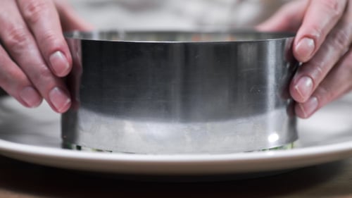 Layered Vegetable Salad Assembled on White Plate