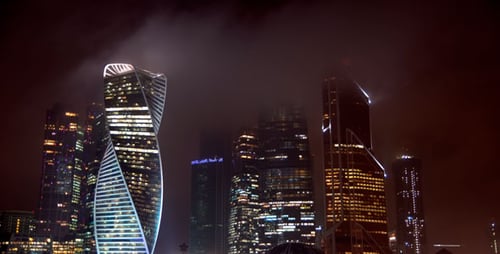 Illuminated Skyscrapers Dominating the Nighttime Cityscape