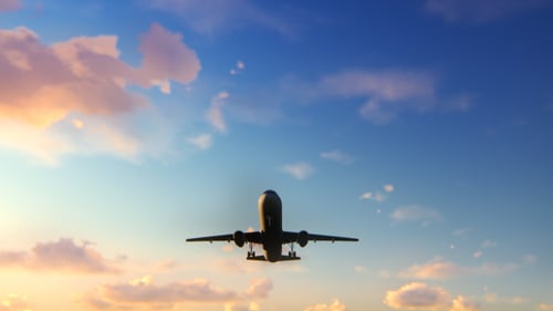 Passenger Jet Taking Off From Runway at Sunset