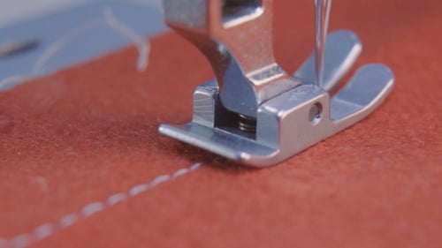 Sewing Machine Stitching Red Fabric Close Up