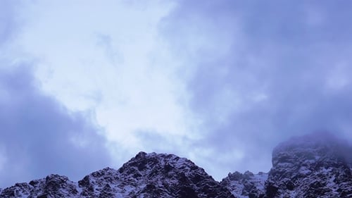 Snowy Peaks of Mountains with Clouds