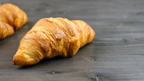Delicious Croissants on a Piece of Old Wood