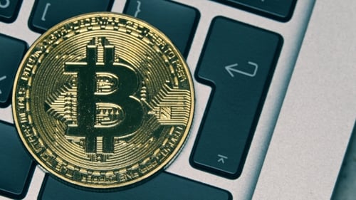 Shiny Bitcoin on the Computer Keyboard Getting Dark