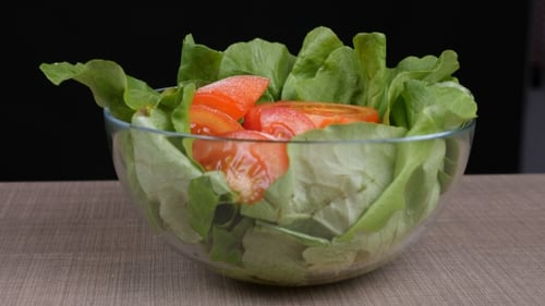 Tomatoes Salad with Green Salad Lefs, Onion and Feta Cheese on Wooden Board