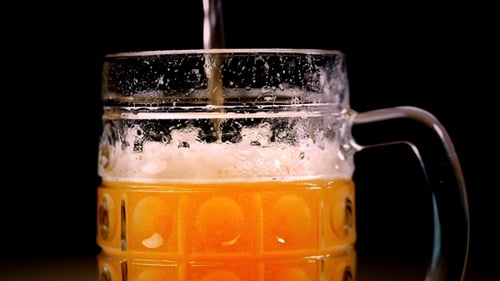 Beer Pouring Into a Glass Mug Close-Up