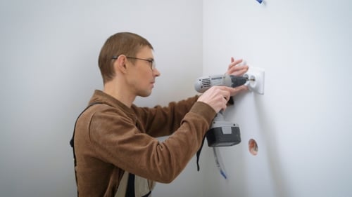 Portrait of an Electrician Who Installs a Socket