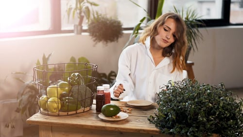 Smiling Woman with Healthy Food at Table