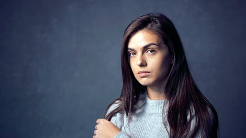 Woman Posing and Smiling in Studio Setting