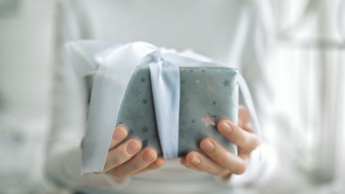Close Up of Gift Wrapped with White Ribbon
